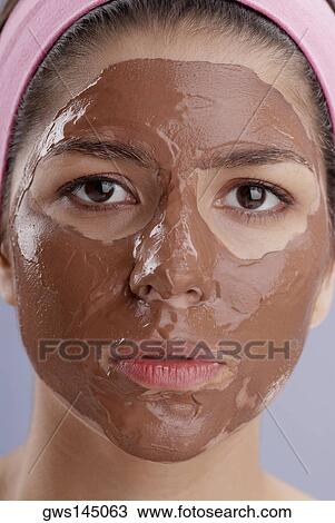 Portrait of a young woman with a facial mask View Large Photo Image Stock Image - Portrait of a young woman with a facial mask. Fotosearch