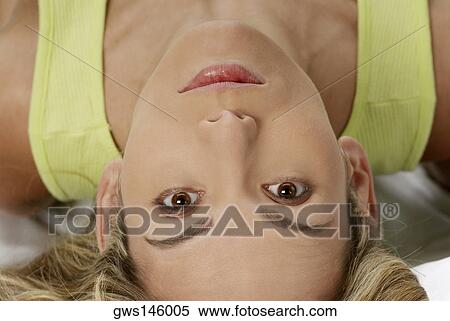 Close-up of a young woman lying down View Large Photo Image Stock Photography - Close-up of a young woman lying down. Fotosearch