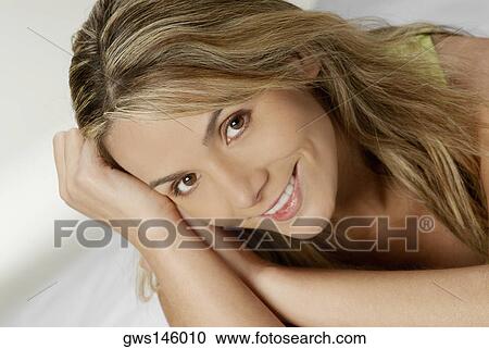 Close-up of a young woman smiling View Large Photo Image Stock Image - Close-up of a young woman smiling. Fotosearch