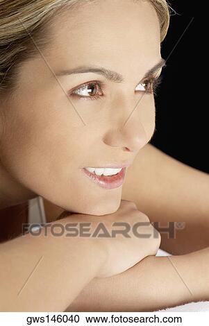 Stock Image - Close-up of a young woman smiling. Fotosearch