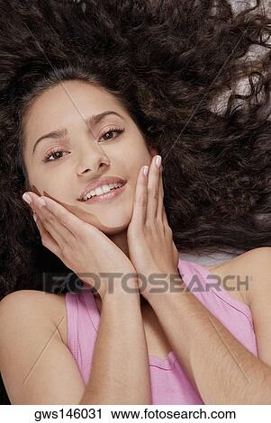 Portrait of a young woman lying down View Large Photo Image Stock Image - Portrait of a young woman lying down. Fotosearch