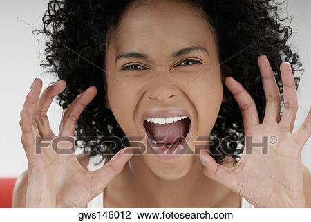 Portrait of a young woman shouting and gesturing with her hands View Large Photo Image Stock Image - Portrait of a young woman shouting and gesturing with her hands. Fotosearch