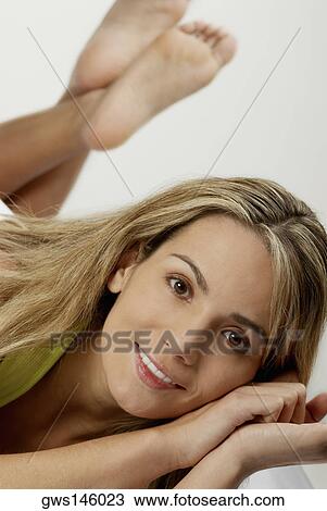Stock Image - Portrait of a young woman smiling. Fotosearch