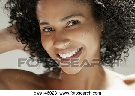 Portrait of a young woman smiling View Large Photo Image Stock Photo - Portrait of a young woman smiling. Fotosearch