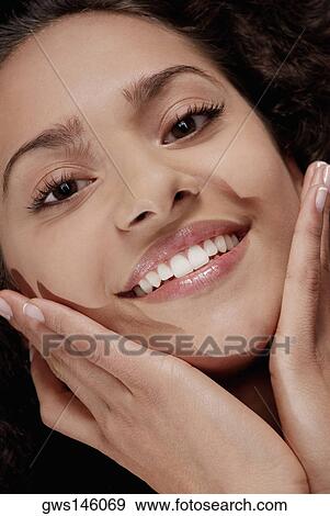Portrait of a young woman smiling View Large Photo Image Stock Photo - Portrait of a young woman smiling. Fotosearch