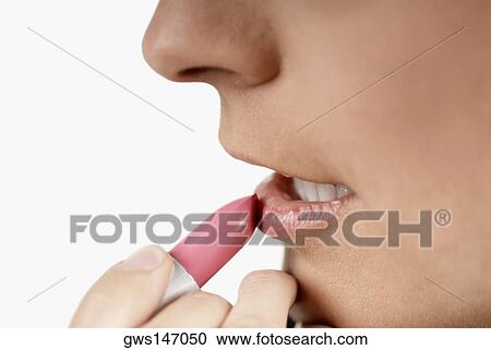 Close-up of a woman applying lipstick View Large Photo Image Stock Image - Close-up of a woman applying lipstick. Fotosearch