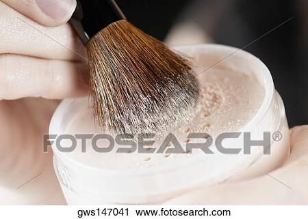 Close-up of a woman's hand holding a pot of face powder and a make-up brush View Large Photo Image Stock Image - Close-up of a woman's hand holding a pot of face powder and a make-up brush. Fotosearch