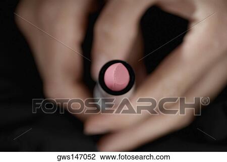 Close-up of a woman's hand holding a lipstick View Large Photo Image Stock Image - Close-up of a woman's hand holding a lipstick. Fotosearch
