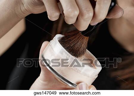 Close-up of a woman's hand holding a pot of face powder and a make-up brush View Large Photo Image Stock Photo - Close-up of a woman's hand holding a pot of face powder and a make-up brush. Fotosearch