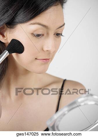 Close-up of a young woman applying blush with a brush View Large Photo Image Stock Photography - Close-up of a young woman applying blush with a brush. Fotosearch