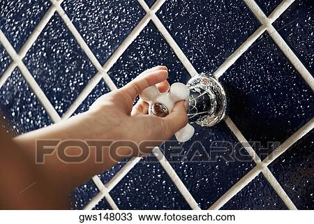 Close-up of a human hand turning a shower knob View Large Photo Image Stock Image - Close-up of a human hand turning a shower knob. Fotosearch