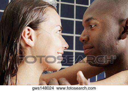 Picture - Close-up of a young couple facing each other in the bathroom. Fotosearch