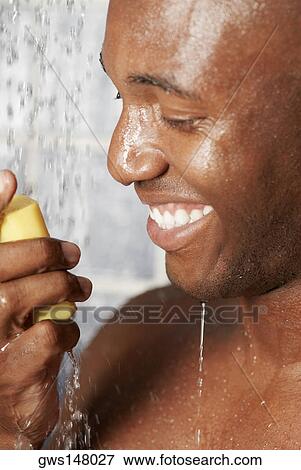 Close-up of a young man holding a bar of soap View Large Photo Image Stock Photo - Close-up of a young man holding a bar of soap. Fotosearch