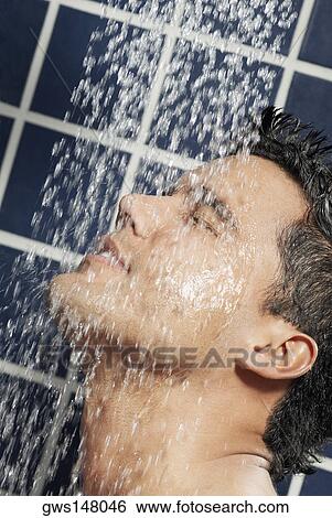 Stock Photograph - Close-up of a young man in the shower. Fotosearch