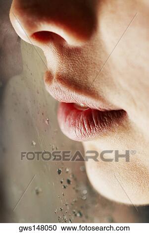 Close-up of a young woman with her face against a glass window View Large Photo Image Stock Image - Close-up of a young woman with her face against a glass window. Fotosearch
