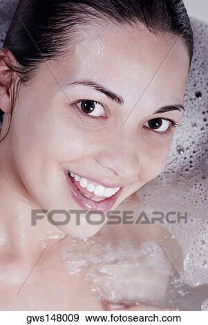 Portrait of a young woman in a bathtub View Large Photo Image Stock Photo - Portrait of a young woman in a bathtub. Fotosearch