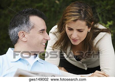 Close-up of a mature man and a mid adult woman reading a newspaper View Large Photo Image Stock Image - Close-up of a mature man and a mid adult woman reading a newspaper. Fotosearch
