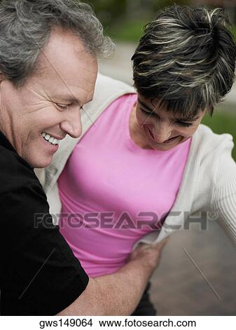 Close-up of a mature man embracing a mature woman and smiling View Large Photo Image Picture - Close-up of a mature man embracing a mature woman and smiling. Fotosearch