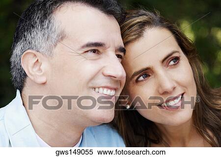 Close-up of a mid adult couple smiling View Large Photo Image Stock Photography - Close-up of a mid adult couple smiling. Fotosearch