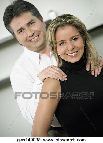 Close-up of a mid adult woman and a mature man smiling together View Large Photo Image Stock Photo - Close-up of a mid adult woman and a mature man smiling together. Fotosearch