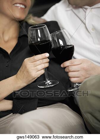Close-up of a woman and a man toasting with wine glasses View Large Photo Image Stock Image - Close-up of a woman and a man toasting with wine glasses. Fotosearch