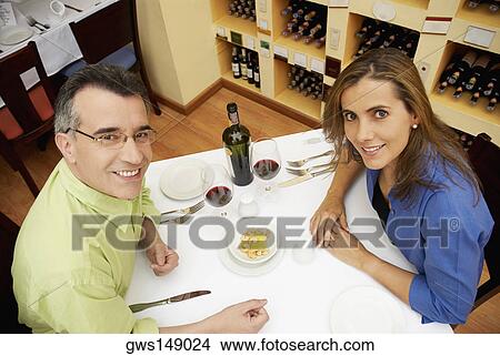 High angle view of a mid adult couple sitting at a table in a restaurant View Large Photo Image Picture - High angle view of a mid adult couple sitting at a table in a restaurant. Fotosearch