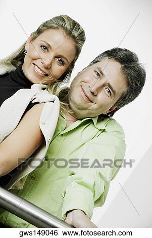 Low angle view of a mature man and a mid adult woman smiling View Large Photo Image Stock Photograph - Low angle view of a mature man and a mid adult woman smiling. Fotosearch