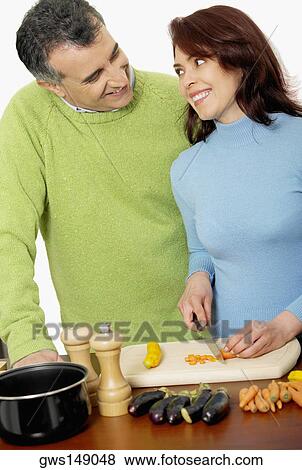 Stock Photo - Mid adult couple making salad. Fotosearch