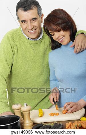 Mid adult couple making salad View Large Photo Image Stock Photograph - Mid adult couple making salad. Fotosearch