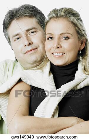 Portrait of a mature man and a mid adult woman smiling View Large Photo Image Stock Image - Portrait of a mature man and a mid adult woman smiling. Fotosearch