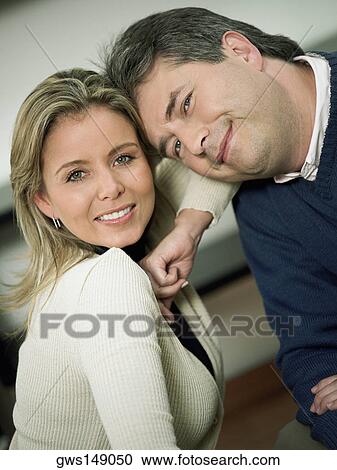 Portrait of a mature man and a mid adult woman smiling View Large Photo Image Stock Image - Portrait of a mature man and a mid adult woman smiling. Fotosearch
