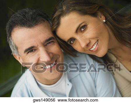 Stock Photograph - Portrait of a mature man and a mid adult woman smiling. Fotosearch