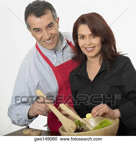 Portrait of a mid adult couple tossing salad View Large Photo Image Stock Image - Portrait of a mid adult couple tossing salad. Fotosearch
