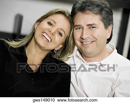 Portrait of a mid adult woman and a mature man smiling View Large Photo Image Stock Image - Portrait of a mid adult woman and a mature man smiling. Fotosearch