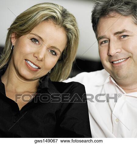 Portrait of a mid adult woman and a mature man smiling View Large Photo Image Stock Photo - Portrait of a mid adult woman and a mature man smiling. Fotosearch