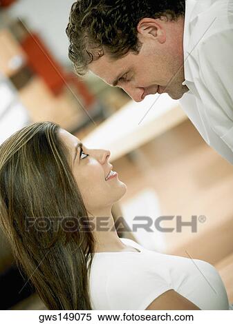 Side profile of a mid adult couple looking at each other View Large Photo Image Stock Photography - Side profile of a mid adult couple looking at each other. Fotosearch