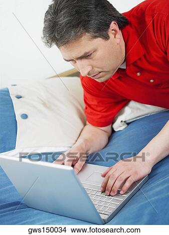 Picture - Close-up of a mature man using a laptop. Fotosearch