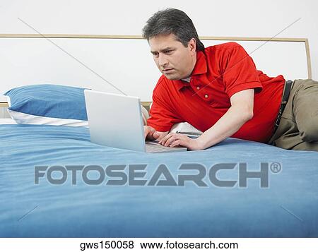 Stock Photo - Close-up of a mature man using a laptop. Fotosearch