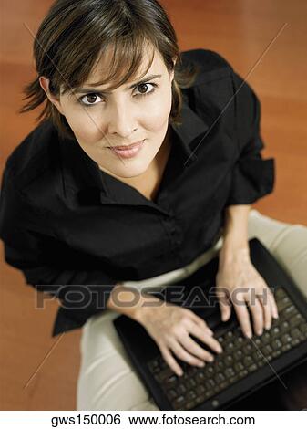 Portrait of a businesswoman using a laptop View Large Photo Image Stock Photograph - Portrait of a businesswoman using a laptop. Fotosearch