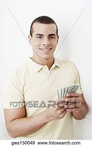 Portrait of a young woman holding dollar bills View Large Photo Image Stock Photo - Portrait of a young woman holding dollar bills. Fotosearch