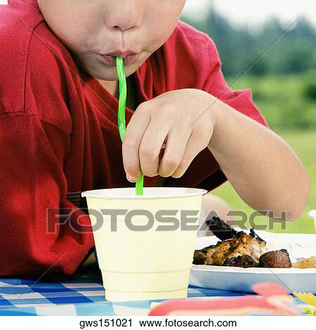 Close-up of a boy drinking with a straw View Large Photo Image Stock Image - Close-up of a boy drinking with a straw. Fotosearch