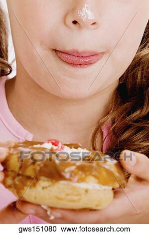 Close-up of a girl holding a bagel with cream on her nose View Large Photo Image Stock Image - Close-up of a girl holding a bagel with cream on her nose. Fotosearch