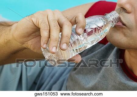 Close-up of a young man drinking water View Large Photo Image Stock Image - Close-up of a young man drinking water. Fotosearch