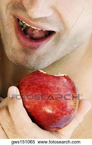 Close-up of a young man eating an apple View Large Photo Image Stock Photography - Close-up of a young man eating an apple. Fotosearch