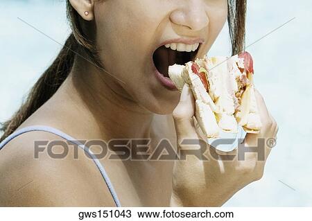 Close-up of a young woman eating a tomato cheese sandwich View Large Photo Image Stock Image - Close-up of a young woman eating a tomato cheese sandwich. Fotosearch