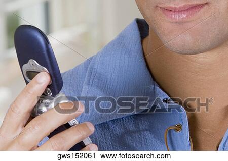 Close-up of a businessman holding a mobile phone View Large Photo Image Stock Image - Close-up of a businessman holding a mobile phone. Fotosearch