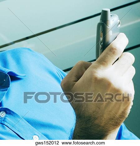 Close-up of a businessman operating a mobile phone View Large Photo Image Stock Image - Close-up of a businessman operating a mobile phone. Fotosearch