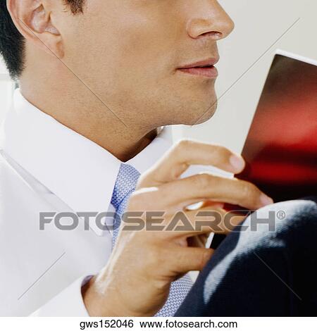 Close-up of a businessman reading a magazine View Large Photo Image Stock Photograph - Close-up of a businessman reading a magazine. Fotosearch