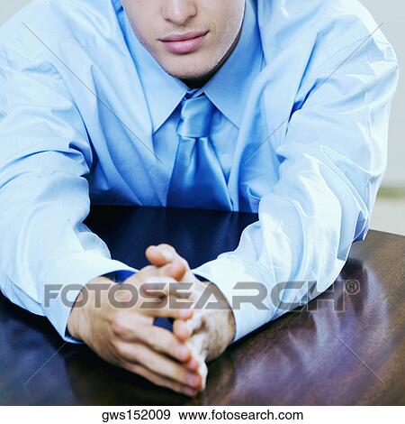 Close-up of a businessman seated at the table View Large Photo Image Stock Photo - Close-up of a businessman seated at the table. Fotosearch
