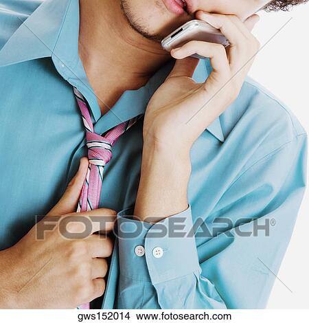 Close-up of a businessman talking on a mobile phone View Large Photo Image Picture - Close-up of a businessman talking on a mobile phone. Fotosearch